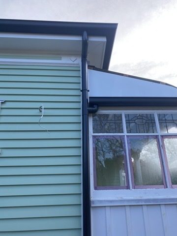 Downpipe replacement on a residential exterior